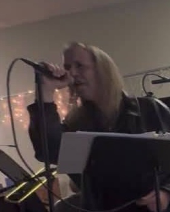 Ryan Evans singing into a microphone